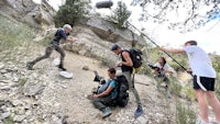a group of people on a rocky trail with a camera